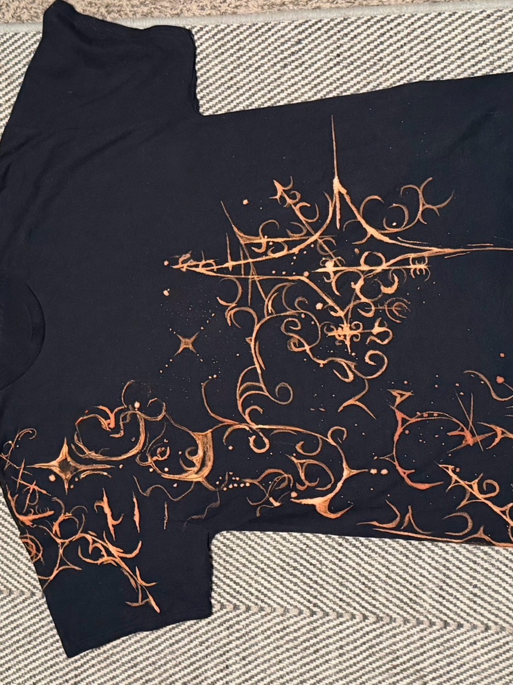 Black Graphic Tee with Copper Starburst Design